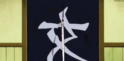 a person is holding a sword in front of a black sign with chinese characters on it .