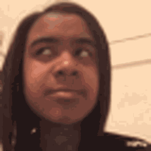a close up of a person 's face with a serious look on her face .