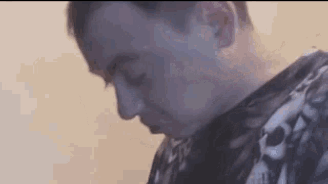 a close up of a man 's face with smoke coming out of his mouth .