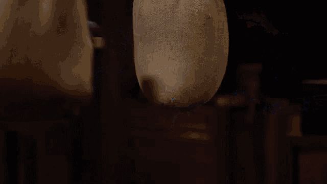 a pile of blue beads is being poured into a bag