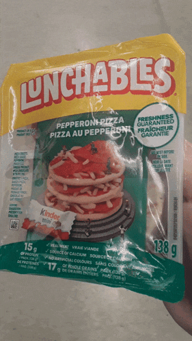 a person is holding a package of lunchables pepperoni pizza pizza au pepperoni