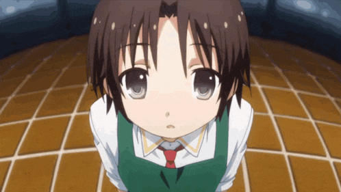 a little girl with brown hair and a green apron is looking up