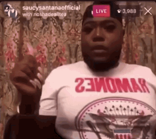a man with a beard is wearing a white t-shirt that says `` 23homa '' .