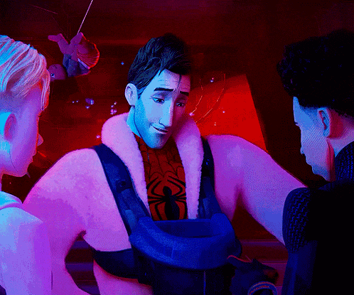 a man in a spiderman costume is talking to another man