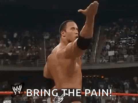 the rock is holding his fist up in the air and saying `` bring the pain ! ''