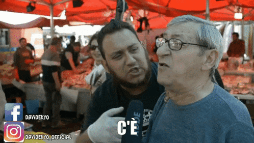 a man talking into a microphone with the word c'e on the bottom