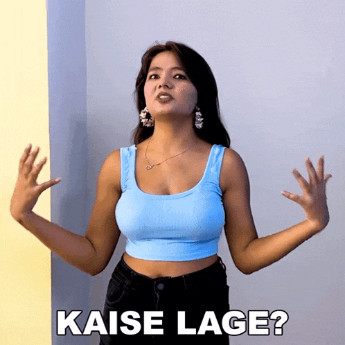 a woman in a blue tank top with the words kaise lage on the bottom