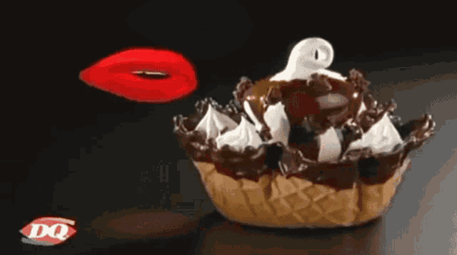 a dq logo is on a black background next to an ice cream cone