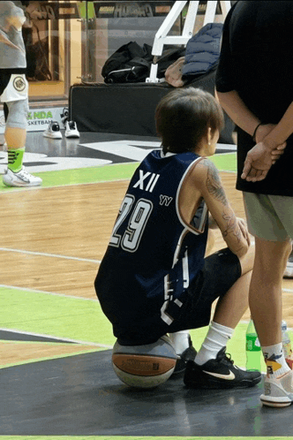 a man wearing a basketball jersey with the number 29 on it