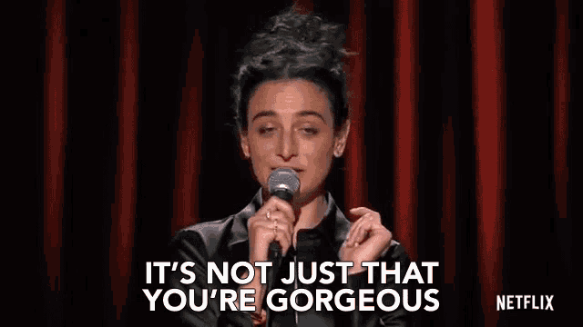 a woman is holding a microphone and saying `` it 's not just that you 're gorgeous ''