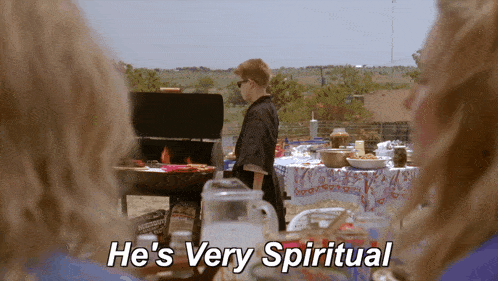 a boy is standing in front of a grill and the words he 's very spiritual are visible