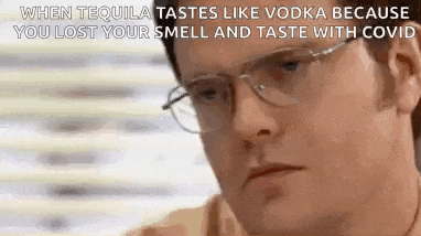 a man wearing glasses is talking about how tequila tastes like vodka because you lost your smell and taste with coronavirus .