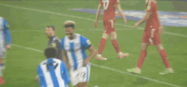 two soccer players wearing blue and white striped uniforms with the number 7 on the back