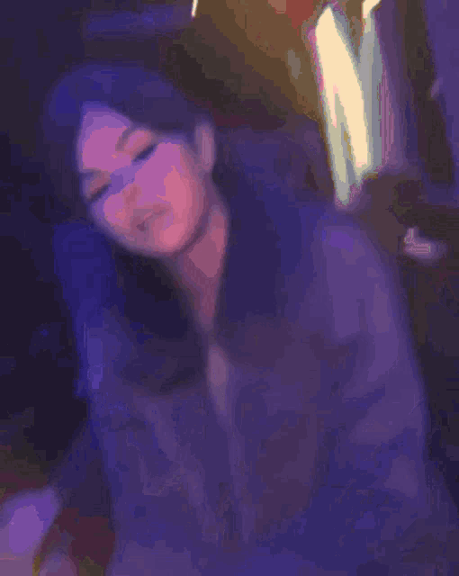 a blurry picture of a woman 's face in a dark room