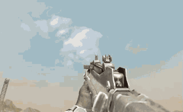a man in a camouflage shirt holds a gun