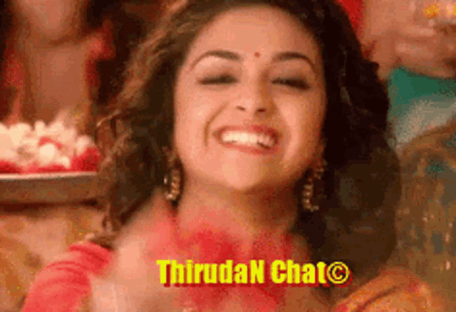 a woman is smiling in front of a sign that says thirugan chat