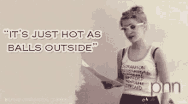 a woman is holding a piece of paper and says it 's just hot as balls outside .