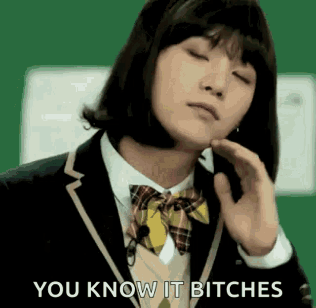 a girl in a school uniform is making a funny face with her eyes closed and the words `` you know it bitches '' .