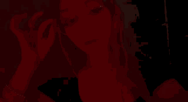 a close up of a woman 's face with a red background