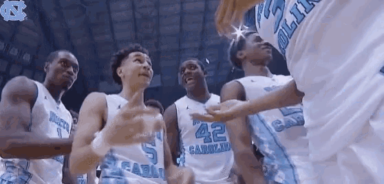 a group of basketball players are huddled together and one of them has the number 42 on their jersey