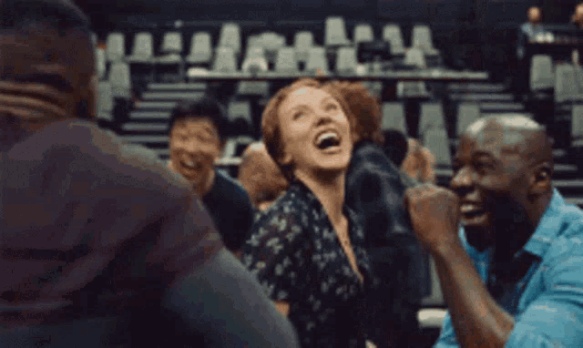a man and a woman are dancing in a crowd of people