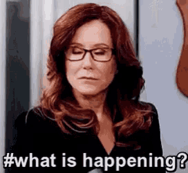 a woman wearing glasses and a black shirt is asking what is happening .