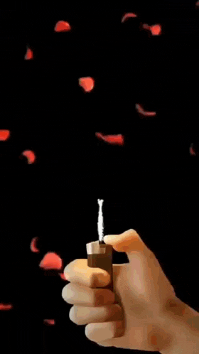 a hand is holding a lighter in front of a picture of a woman
