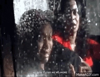 a man and a woman are sitting in a car looking out a window .