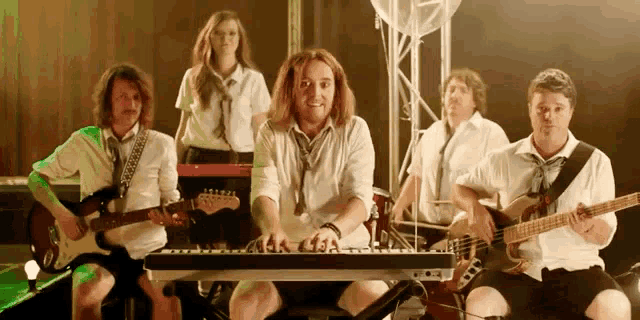 a group of people are playing instruments including a keyboard that says 44k