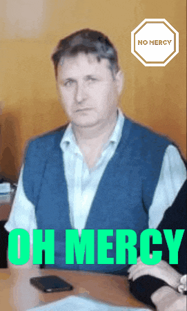 a man sits at a desk with the words oh mercy written on the bottom