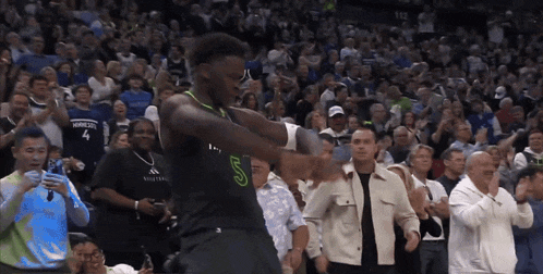 a basketball player wearing a black jersey with the letter s on it