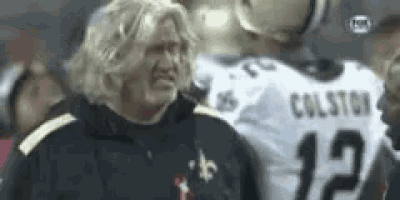 a man wearing a wig is standing next to a football player wearing a number 12 jersey .
