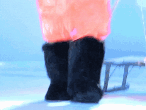 a person wearing a pink jacket and black boots