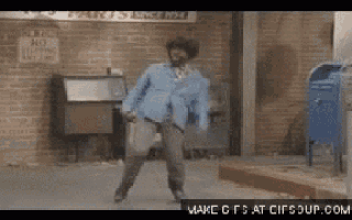 a man is dancing in front of a brick wall with a no parking sign
