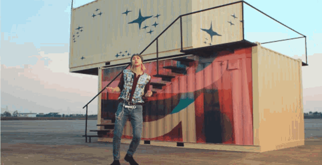 a man is dancing in front of a building that says tl on it