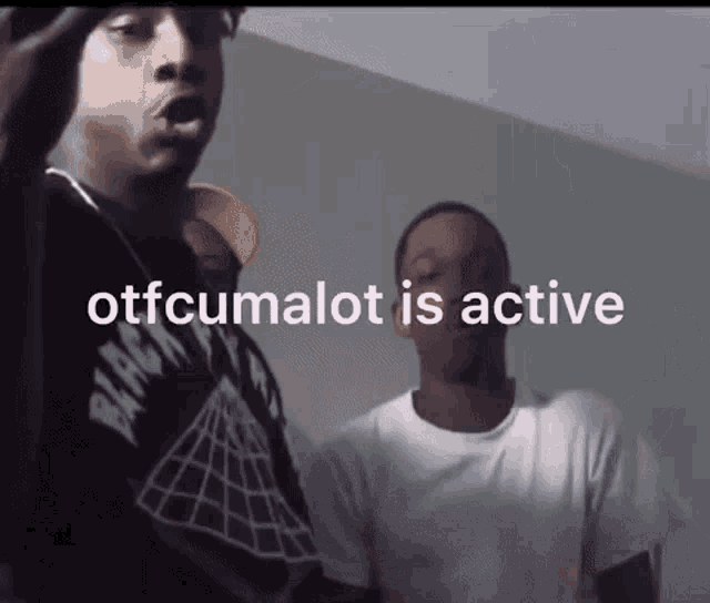 two men are standing next to each other with the words " otfcumalot is active " written above them