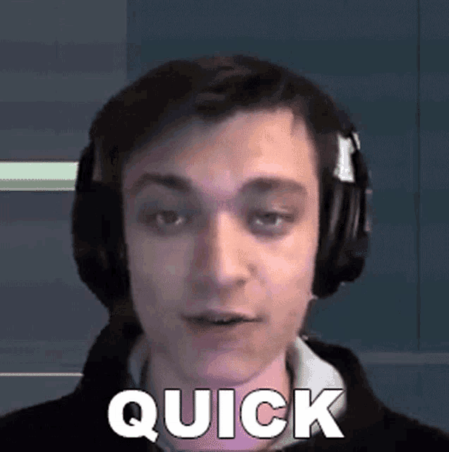 a man wearing headphones with the word quick written on his face