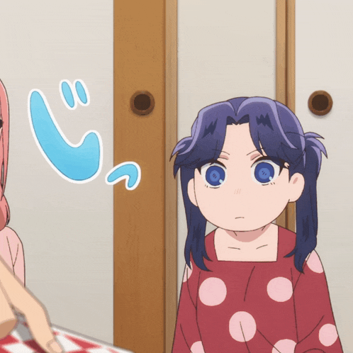 a girl with blue eyes is standing next to another girl in a polka dot shirt