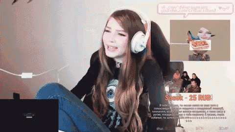a woman wearing headphones sits in front of a screen that says sosok 25 rub on it