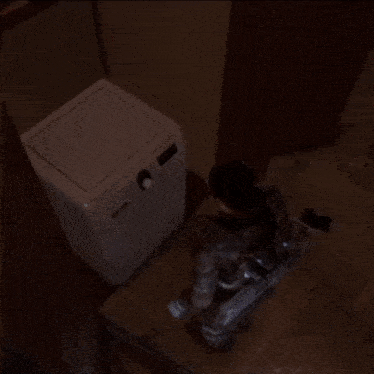 a person laying on the floor in a dark room
