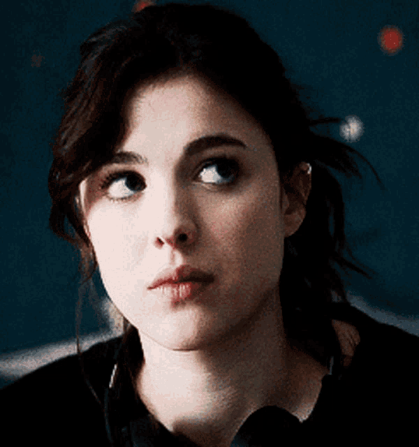 a close up of a woman 's face with dark hair