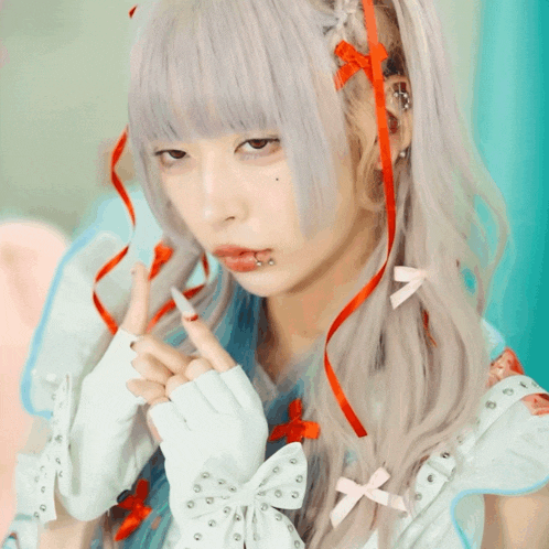 a girl with a piercing in her lip is wearing a white dress