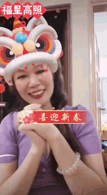 a woman wearing a balloon lion head with chinese characters on it