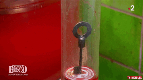 a bottle of red liquid with the number 2 on the bottom of it