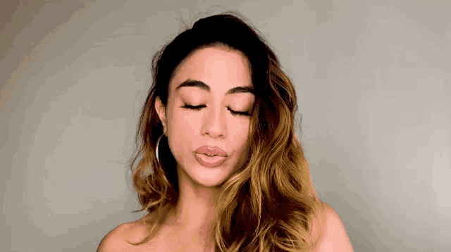 a woman with her eyes closed has a pink lip