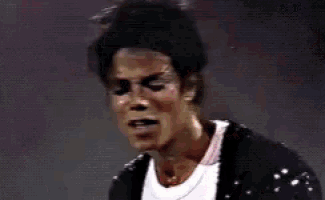 a close up of a man 's face with a reflection of a man in the background