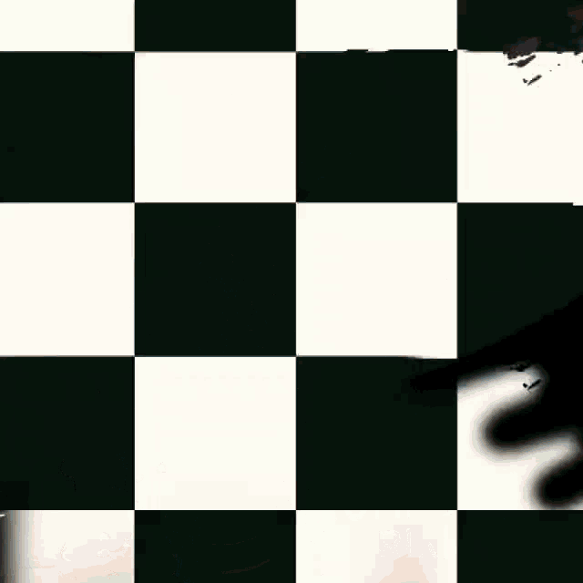 a man in a leather jacket stands in front of a checkered background