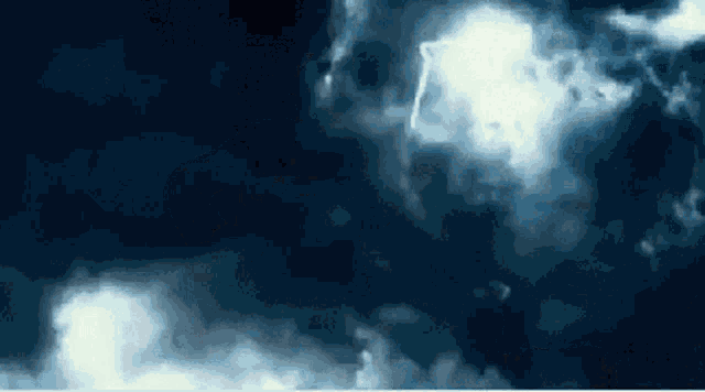 a lightning bolt is shining through the clouds in a dark sky