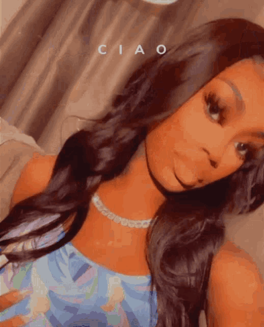 a woman taking a selfie with the word ciao written on the bottom