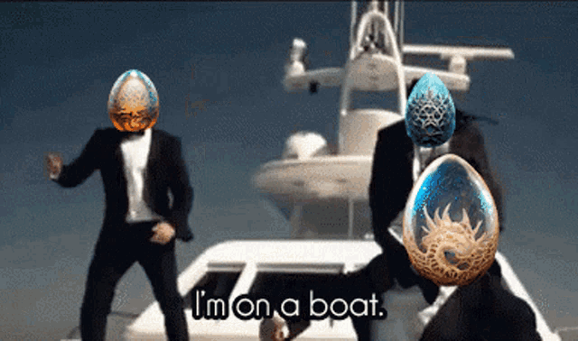 two men in suits are dancing in front of a boat with the words " i 'm on a boat " on the bottom